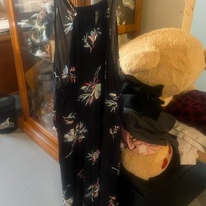 Long black dress front shorter string goes all around top part. No sleeves